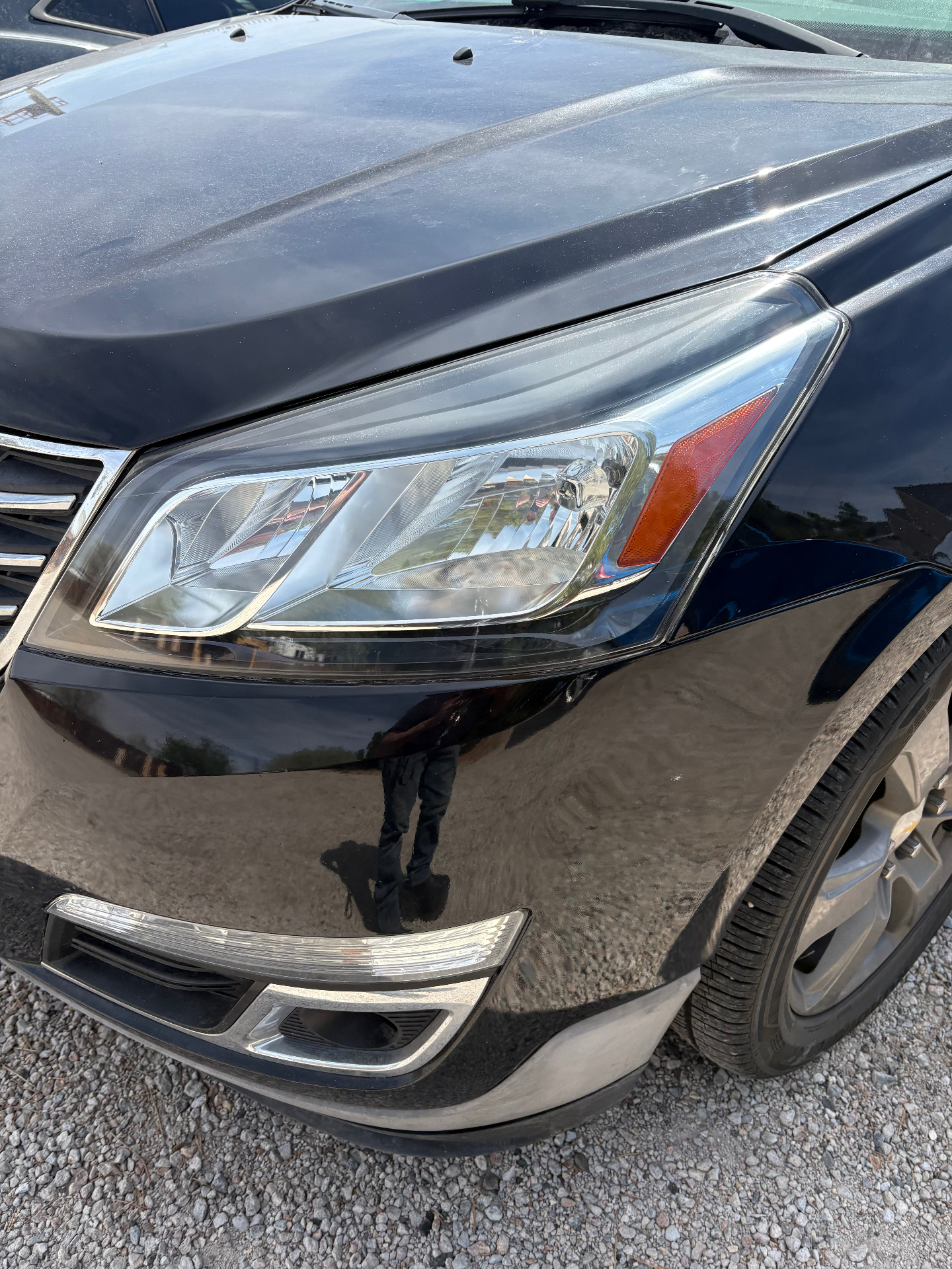 Black SUV headlight after restoration with restored clarity