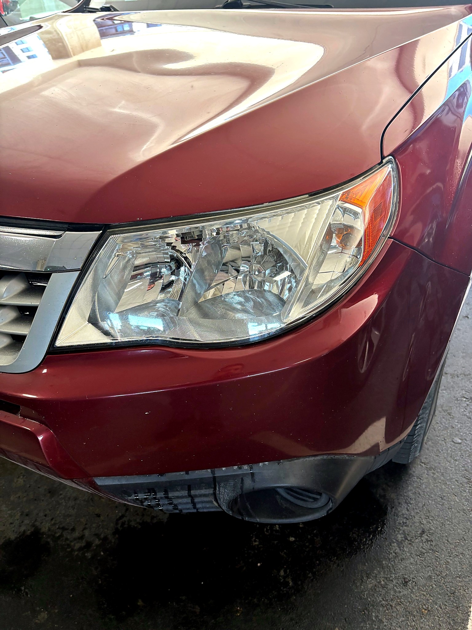 Red vehicle headlight after restoration with improved clarity