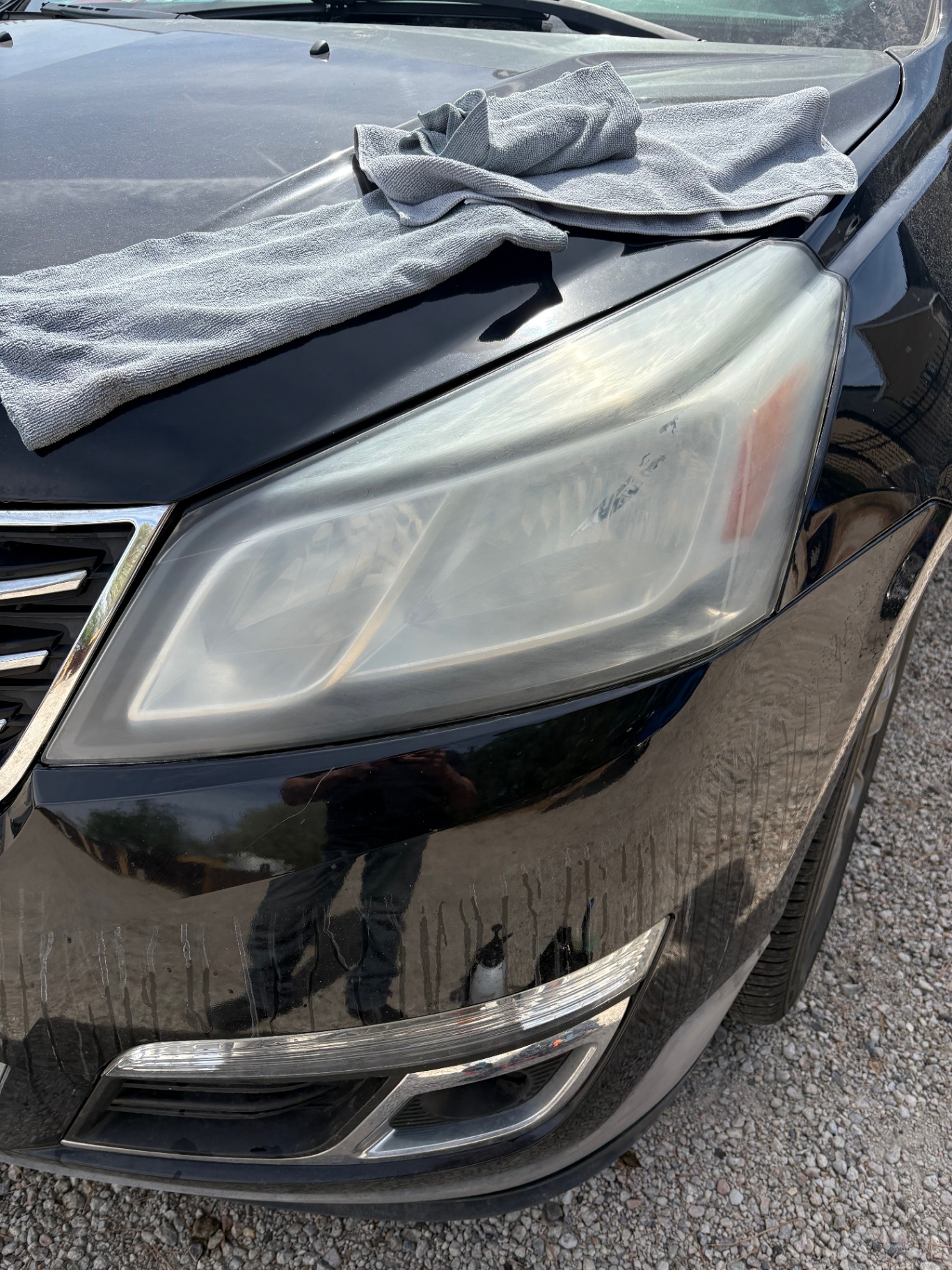 Black SUV with hazed, cloudy headlight before restoration