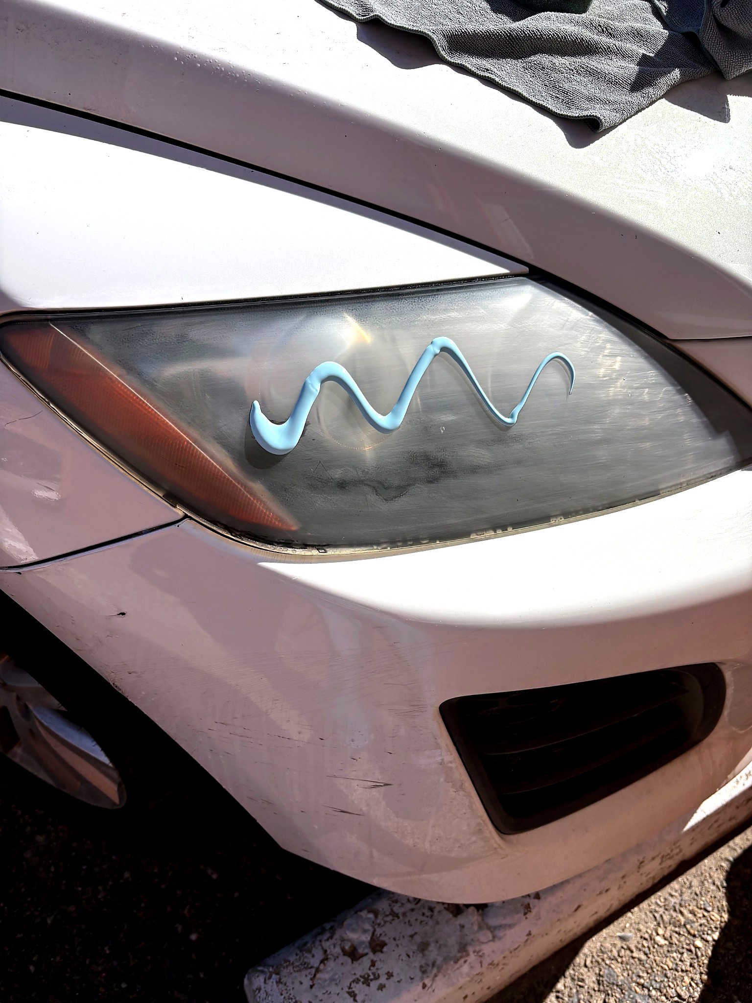 White vehicle headlight during restoration process