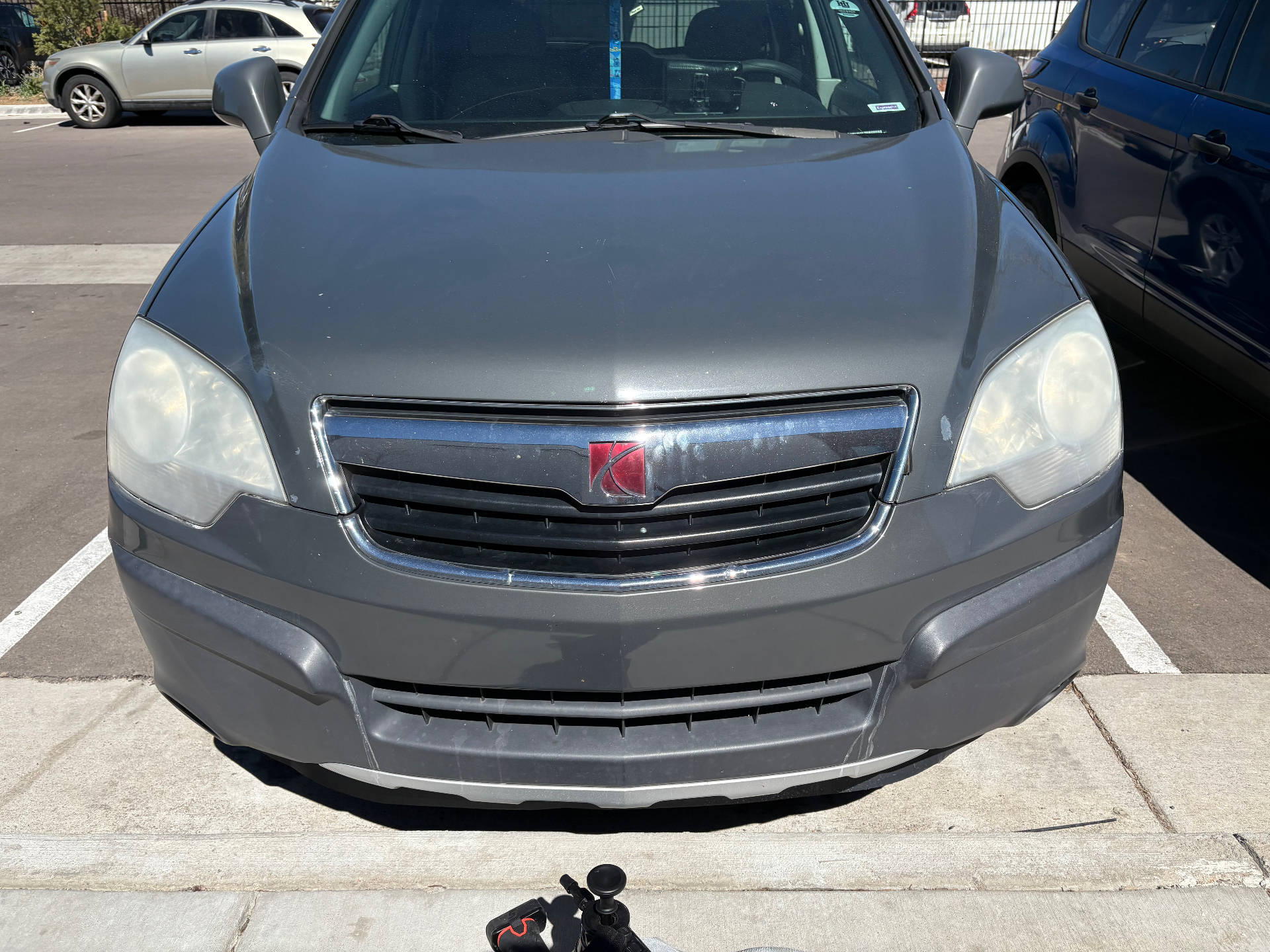 Gray SUV front with cloudy, yellowed headlights before restoration